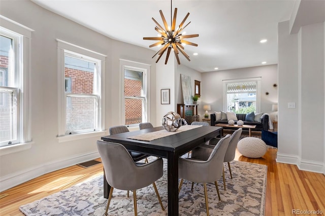 dining room featuring an inviting chandelier and light hardwood / wood-style floors