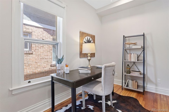 office space featuring a healthy amount of sunlight and wood-type flooring