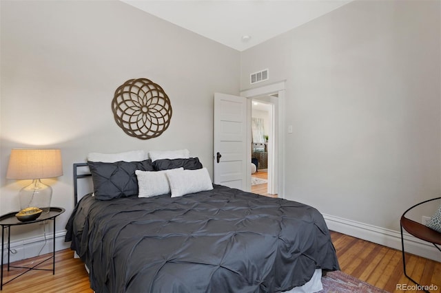 bedroom featuring a baseboard radiator and wood-type flooring