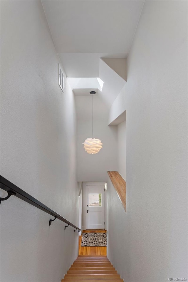 staircase with wood-type flooring