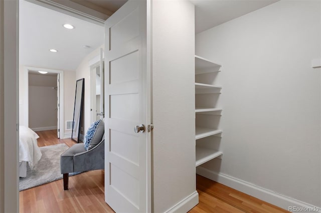 hallway with hardwood / wood-style floors