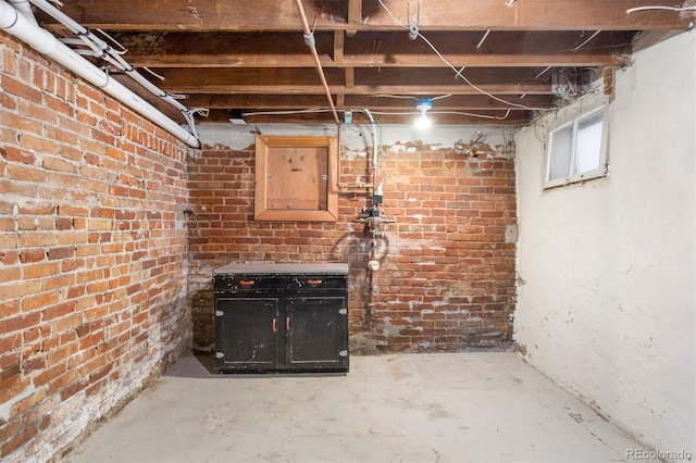 basement featuring brick wall