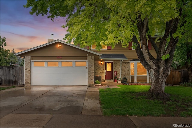 10450 Iris Way, Broomfield, CO 80021 - view of front of home with concrete driveway, brick siding, and a garage