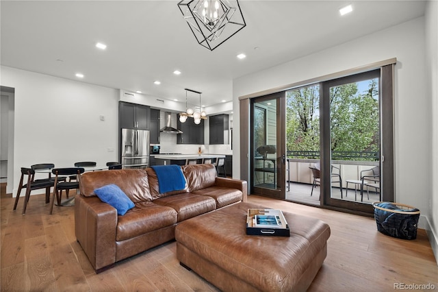 living room featuring an inviting chandelier and light hardwood / wood-style floors