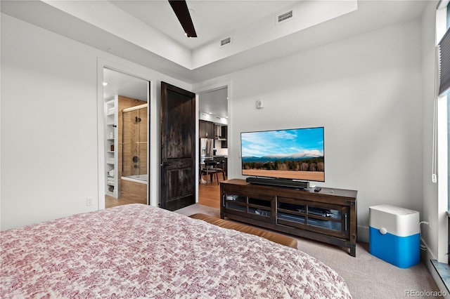 bedroom with ceiling fan and ensuite bath