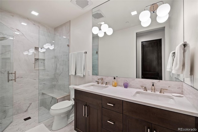 bathroom featuring an enclosed shower, backsplash, vanity, and toilet