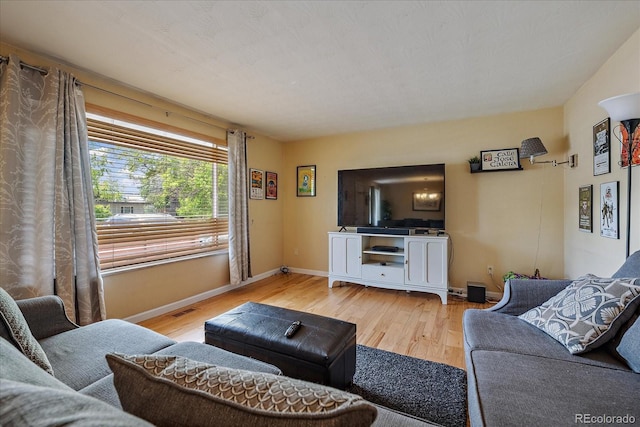 4855 E Atlantic Pl, Denver, CO 80222 - living room featuring light wood-style flooring and baseboards