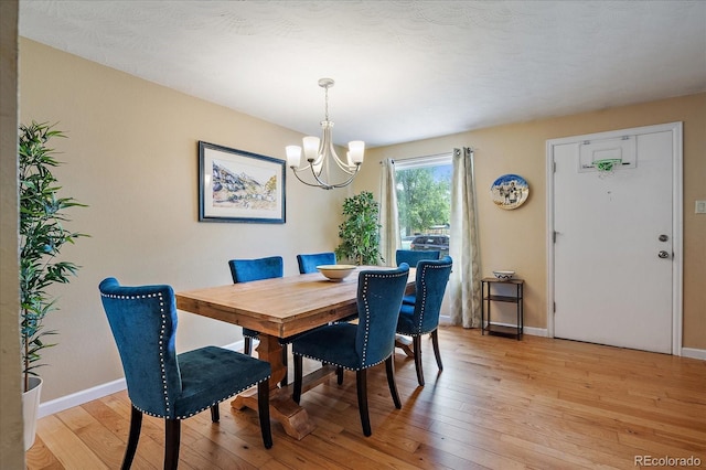 4855 E Atlantic Pl, Denver, CO 80222 - dining area with a chandelier, light wood-style floors, and baseboards