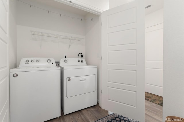 washroom with light wood-type flooring and washer and clothes dryer