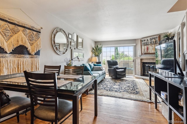 1818 S Quebec Way Unit 4, Denver, CO 80231 - dining room featuring a brick fireplace and wood finished floors