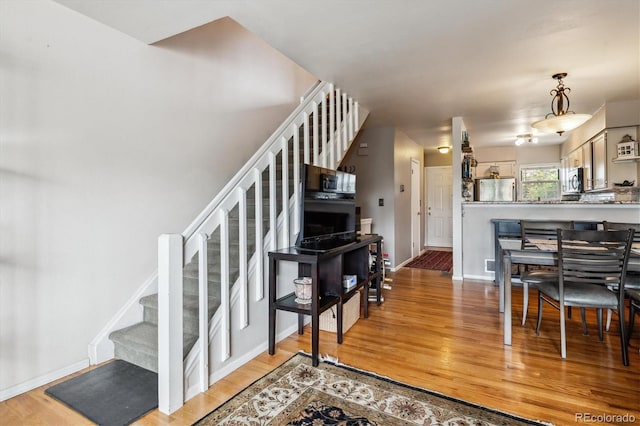 1818 S Quebec Way Unit 4, Denver, CO 80231 - stairs featuring wood finished floors and baseboards