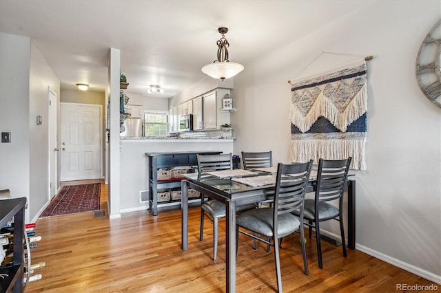 1818 S Quebec Way Unit 4, Denver, CO 80231 - dining space featuring light wood-type flooring and baseboards