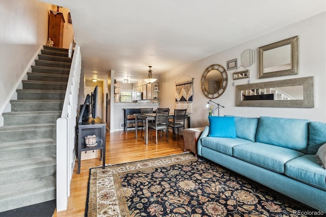 1818 S Quebec Way Unit 4, Denver, CO 80231 - living room with light wood-style floors and stairway