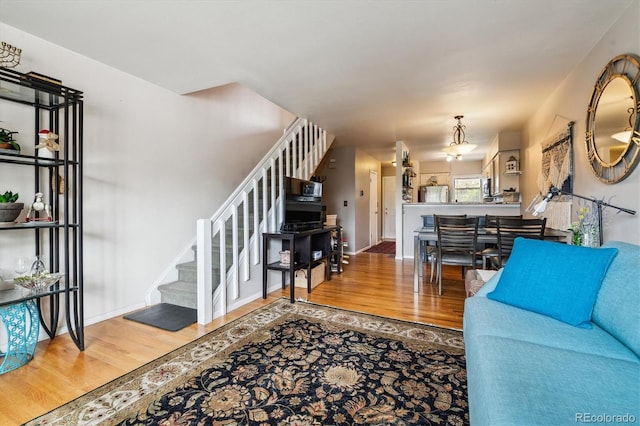 1818 S Quebec Way Unit 4, Denver, CO 80231 - living area featuring wood finished floors, stairway, and baseboards