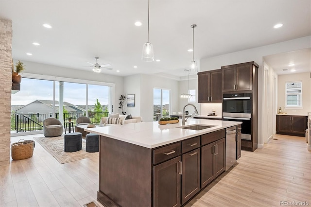 22183 E Rocky Top Pl, Aurora, CO 80016 - kitchen with ceiling fan, appliances with stainless steel finishes, light countertops, dark brown cabinetry, and open floor plan