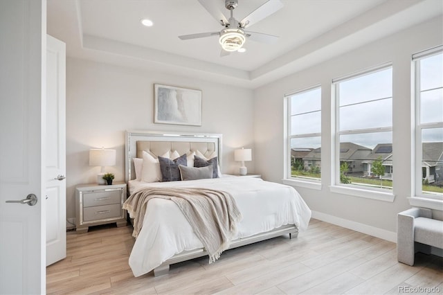 22183 E Rocky Top Pl, Aurora, CO 80016 - bedroom featuring a raised ceiling, light wood-style floors, recessed lighting, and ceiling fan