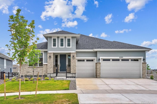 22183 E Rocky Top Pl, Aurora, CO 80016 - view of front facade with a garage, driveway, a front yard, stone siding, and roof with shingles