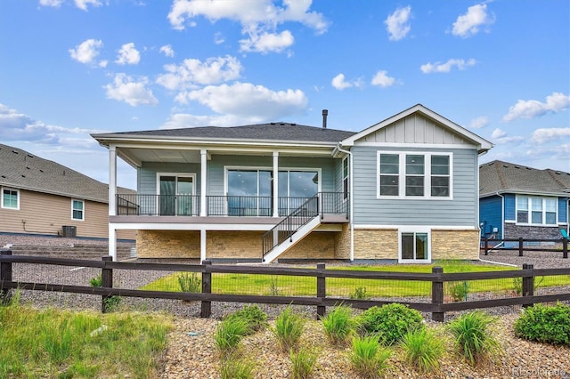22183 E Rocky Top Pl, Aurora, CO 80016 - rear view of property with stone siding, board and batten siding, and stairway