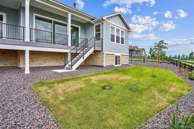 22183 E Rocky Top Pl, Aurora, CO 80016 - view of home's exterior with board and batten siding, stone siding, and stairway