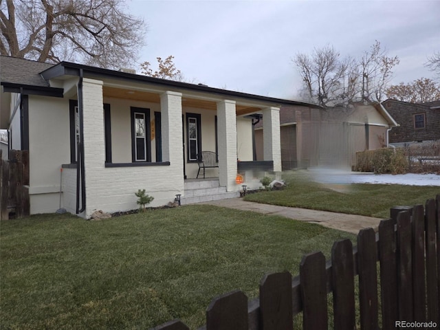 ranch-style house with a front yard and a porch