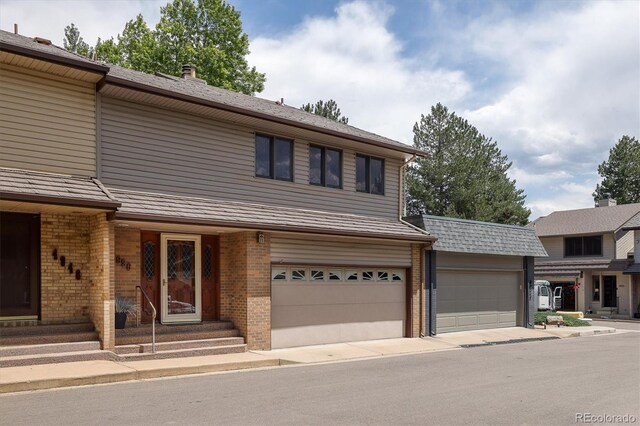 4936 Clubhouse Cir, Boulder, CO 80301 - view of front facade with brick siding, entry steps, and an attached garage