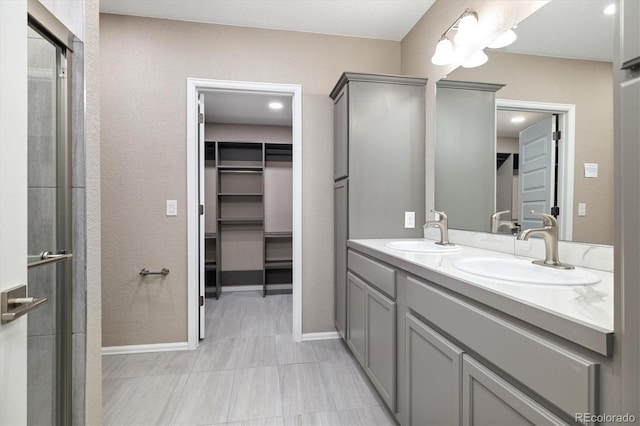 6725 Mentha Dr, Castle Rock, CO 80108 - bathroom featuring a sink, a walk in closet, a stall shower, and double vanity