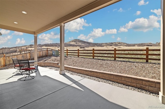 6725 Mentha Dr, Castle Rock, CO 80108 - view of patio with a fenced backyard, central AC unit, and a mountain view