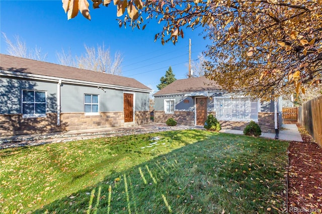 view of front facade with a front lawn and a patio area