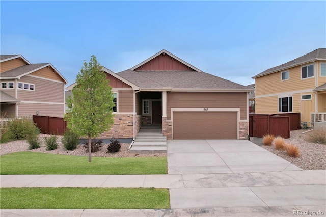 1867 Abundance Dr, Windsor, CO 80550 - craftsman-style house with fence, stone siding, a garage, board and batten siding, and concrete driveway