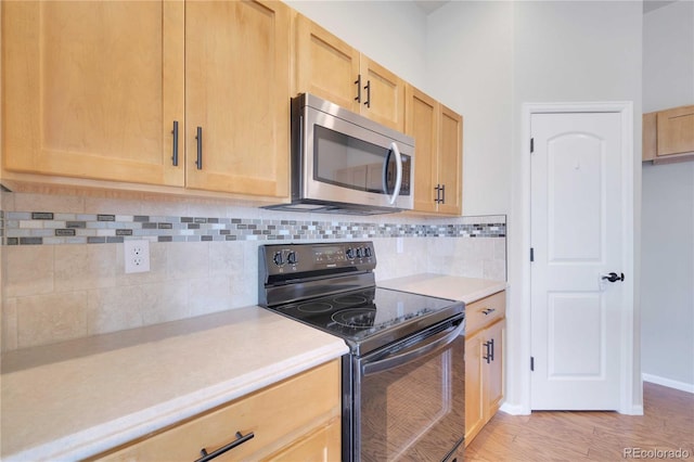 1867 Abundance Dr, Windsor, CO 80550 - kitchen featuring light countertops, electric range, stainless steel microwave, and light brown cabinets