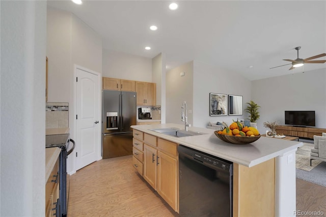 1867 Abundance Dr, Windsor, CO 80550 - kitchen with light brown cabinets, open floor plan, light countertops, a sink, and black appliances
