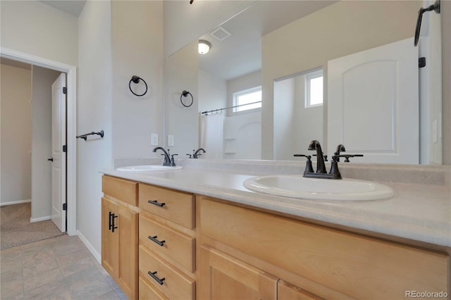 1867 Abundance Dr, Windsor, CO 80550 - full bathroom with visible vents, a sink, baseboards, and double vanity