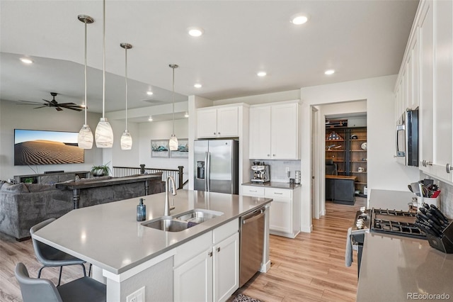 12841 Lake Port St, Longmont, CO 80504 - kitchen featuring stainless steel appliances, light wood-style flooring, ceiling fan, hanging light fixtures, and recessed lighting