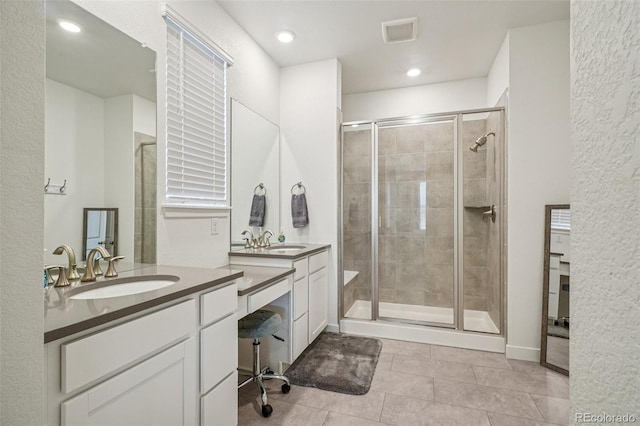 12841 Lake Port St, Longmont, CO 80504 - full bath with a stall shower, two vanities, tile patterned flooring, and recessed lighting
