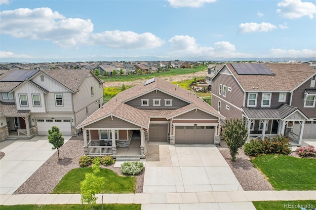 12841 Lake Port St, Longmont, CO 80504 - craftsman-style house with a residential view, a porch, driveway, stone siding, and a garage