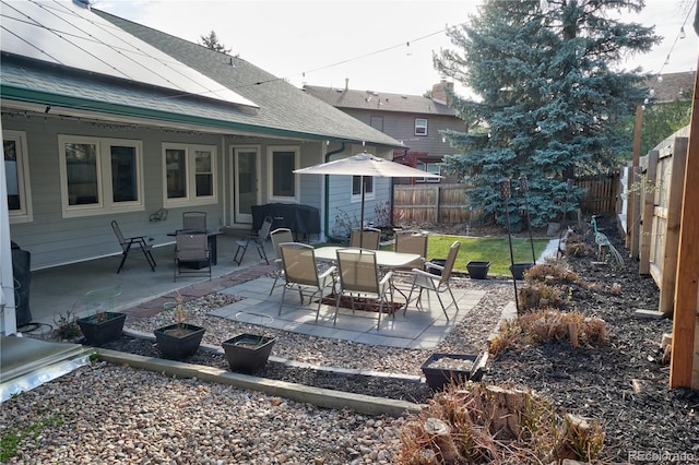 view of patio featuring a fenced backyard and outdoor dining area