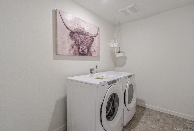 clothes washing area featuring washing machine and dryer