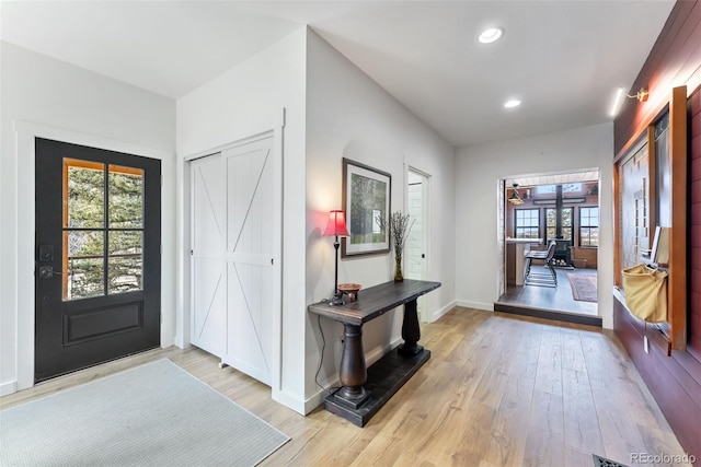 entryway featuring recessed lighting, light wood finished floors, and baseboards