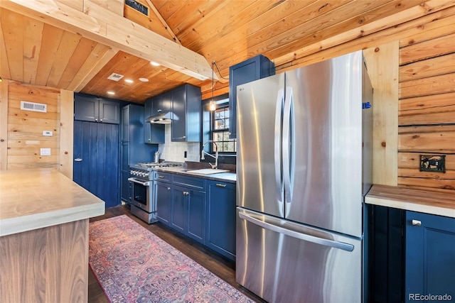 kitchen with stainless steel appliances, visible vents, a sink, and blue cabinetry