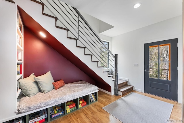 entrance foyer with a wealth of natural light, baseboards, wood finished floors, and stairs