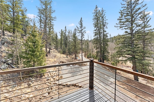 balcony featuring a forest view