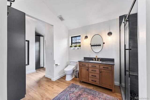 full bath with vanity, visible vents, toilet, wood finished floors, and baseboards