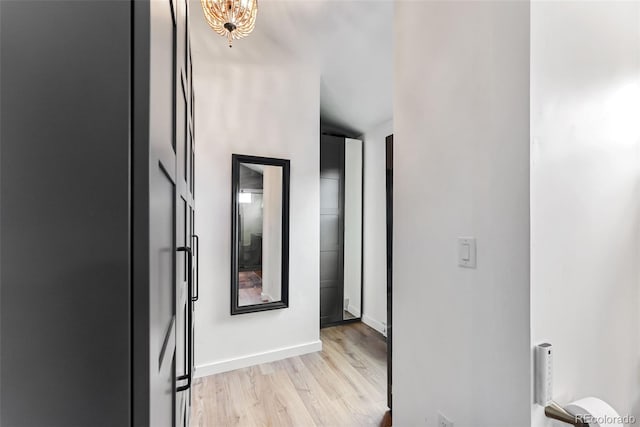 hall featuring baseboards and light wood-style floors