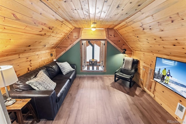 living room featuring wooden walls, wood ceiling, hardwood / wood-style floors, and lofted ceiling