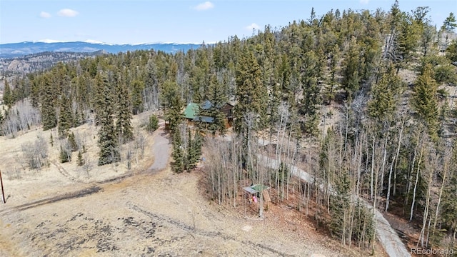 drone / aerial view featuring a forest view and a mountain view