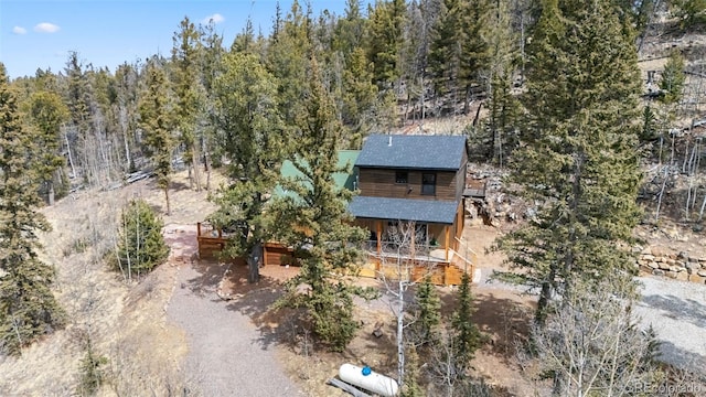 birds eye view of property featuring a view of trees