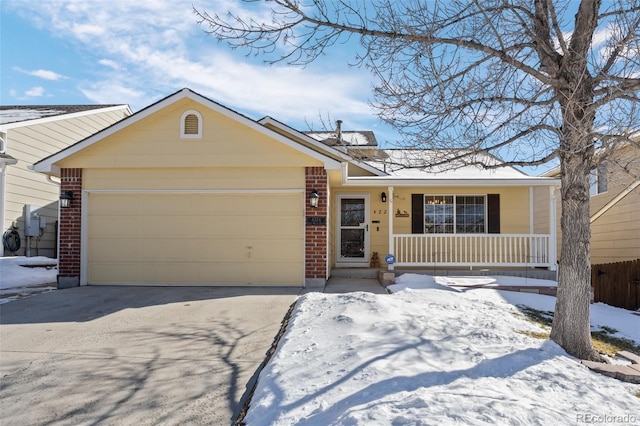 single story home featuring a garage and a porch