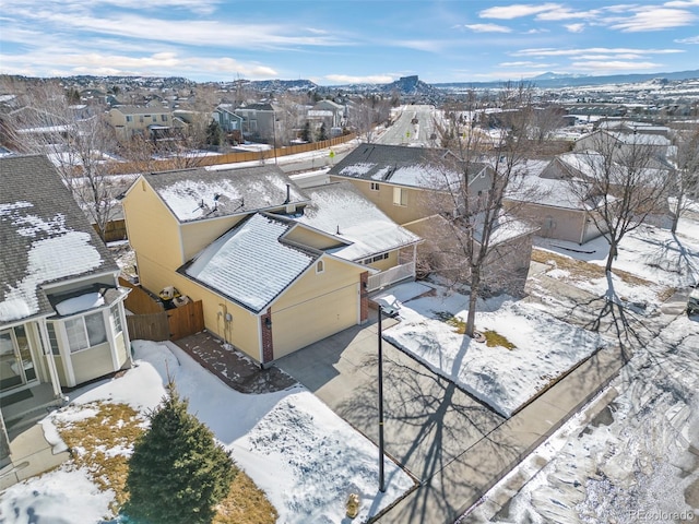 snowy aerial view featuring a mountain view