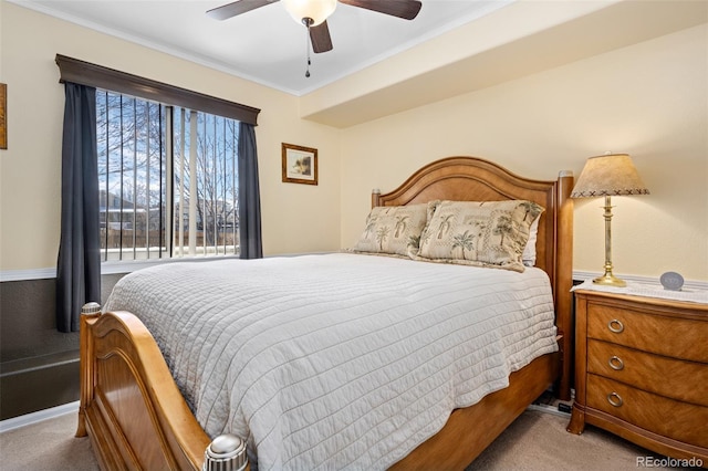 bedroom featuring crown molding, light carpet, and ceiling fan