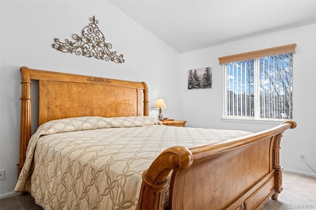 carpeted bedroom featuring lofted ceiling